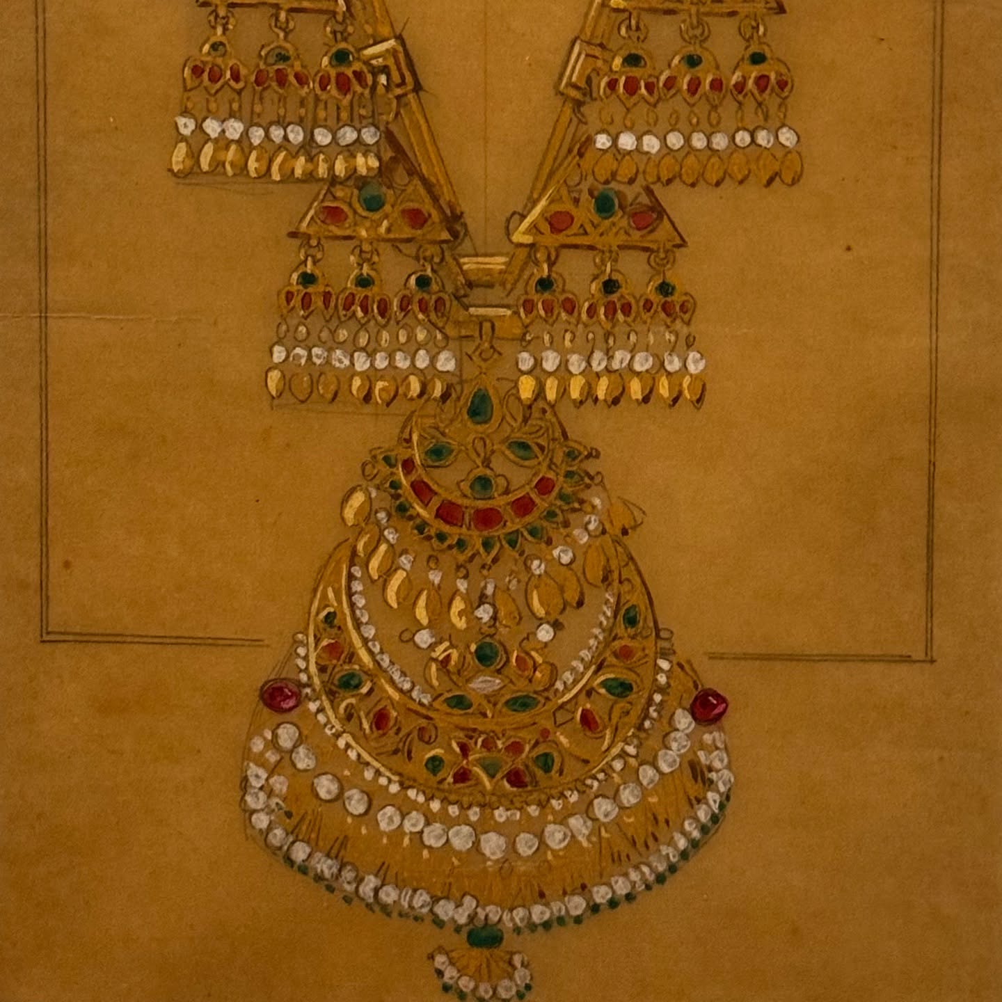 Vintage design drawing of an elaborate gold necklace with rubies, emeralds, and diamonds.