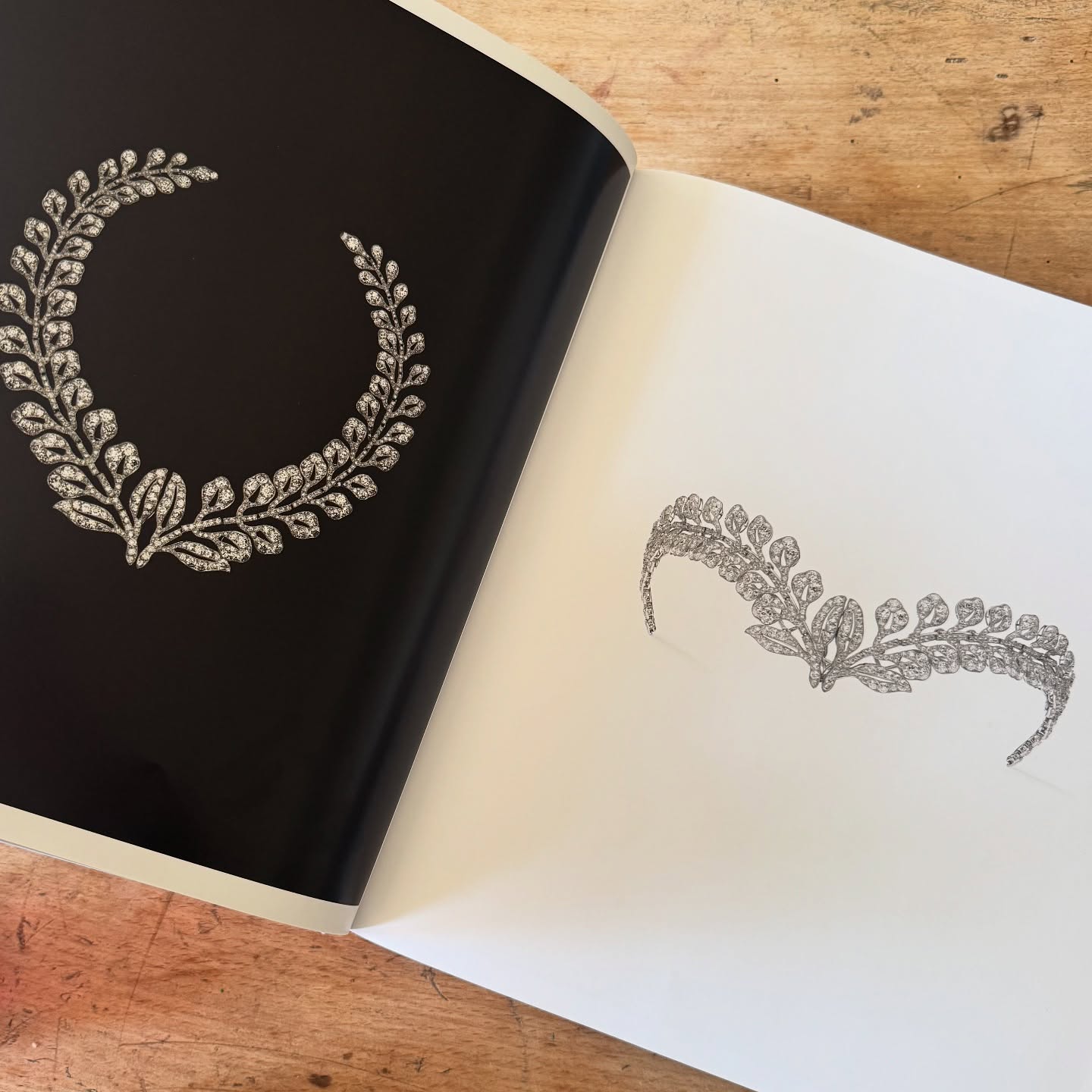 Open book showing two diamond wreath jewellery designs: a necklace and a tiara.