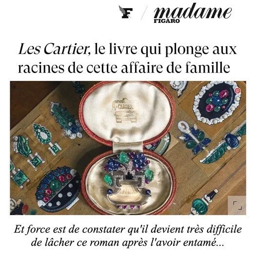 Vibrant diamond, sapphire, ruby, and emerald brooch in a Cartier box, with other designs.