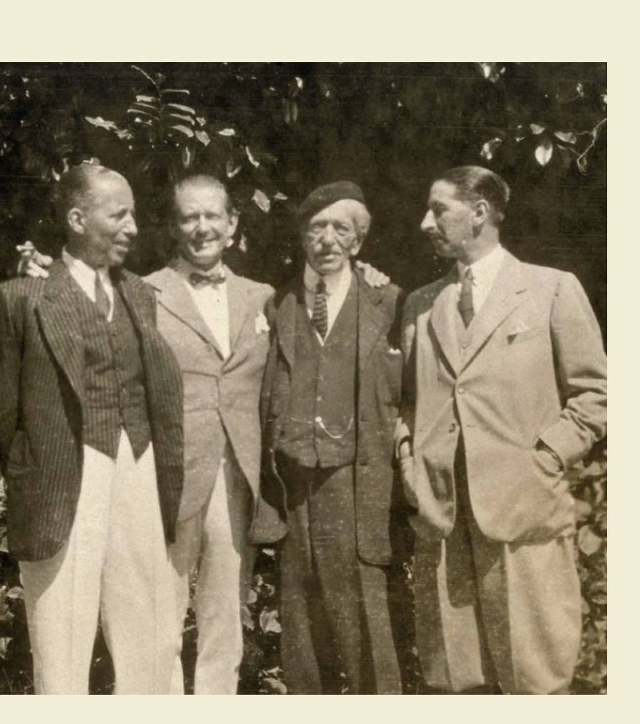 Four men in suits standing together outdoors, believed to be the Cartier brothers and associates in a vintage photograph.